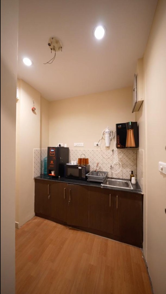 Office pantry with coffee machine, microwave, and sink